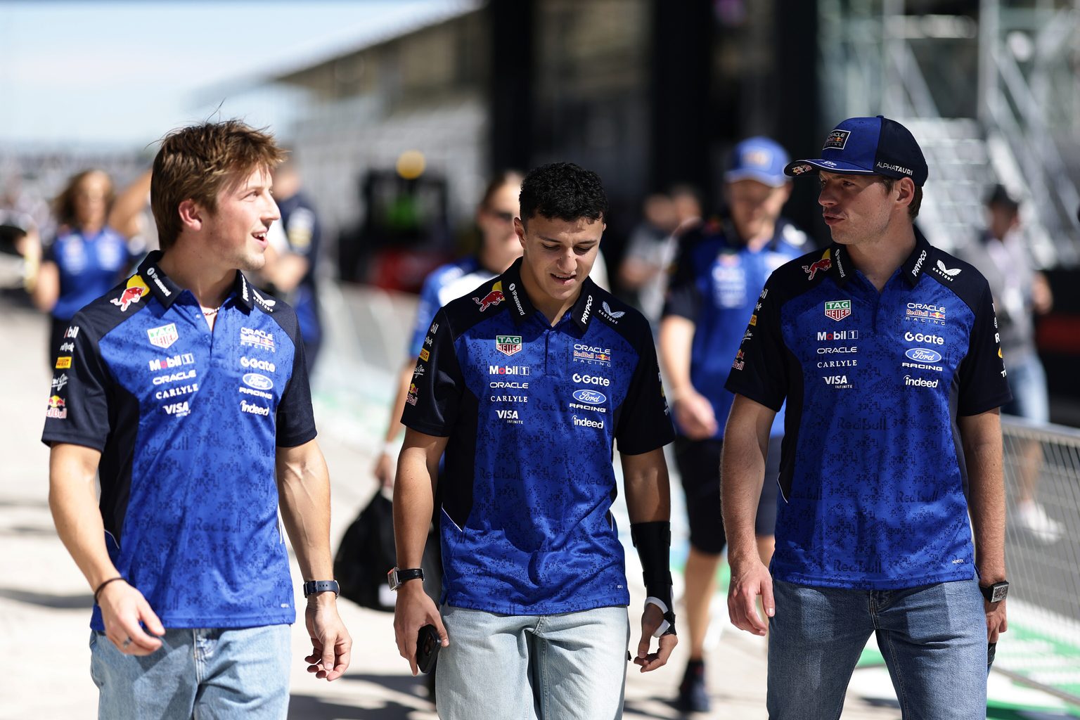 Max Verstappen, Isack Hadjar, and Liam Lawson of Oracle Red Bull Racing talk in the pitlane ahead of the F1 Grand Prix of Spain at Madring on September 10, 2026 in Madrid, Spain.