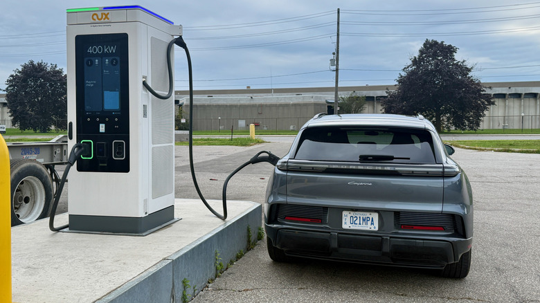 Задня частина Porsche Cayenne Electric, що заряджається на станції потужністю 400 кВт.