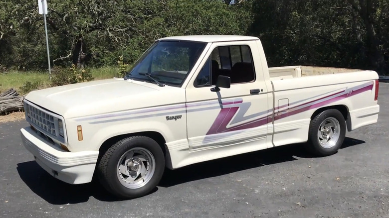 A white Ford Ranger GT sits in a parking lot with zigzagging purple streaks running down the side.