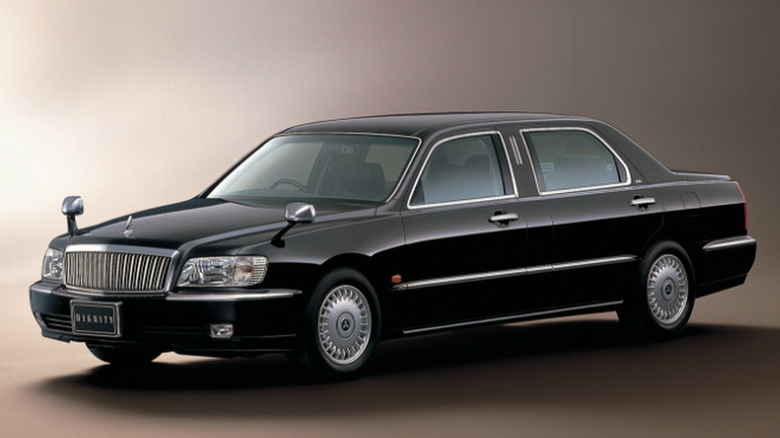 Студійний знімок чорного седана Mitsubishi Dignity 2000 року.
