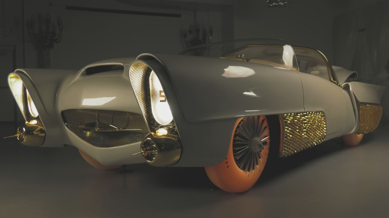 The Golden Sahara II showcase car used by Goodyear to exhibit its glowing tire technology, parked in a studio.