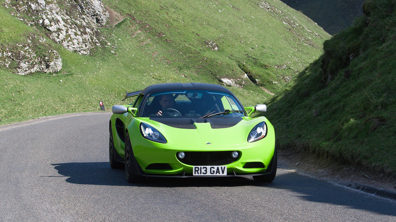 Яскраво-зелений Lotus Elise їде гірським перевалом