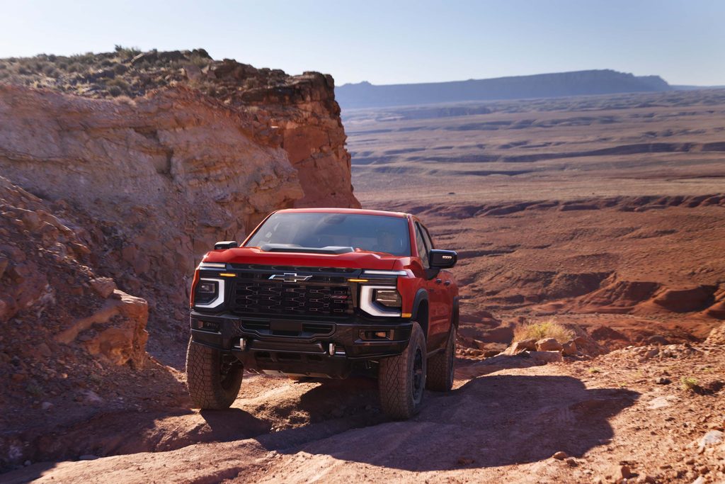 2027 Chevrolet Silverado 1500 ZR2 Bison in Apex Red shown in a desert setting.