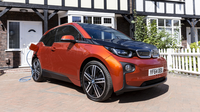 LONDON, UNITED KINGDOM - JULY 21: Go Ultra Low BMW i3 REX on charge on a London driveway on July 21, 2015 in London, England. Ultra-low emission vehicles such as this can cost as little as 2p per mile to run and some electric cars and vans have a range of up to 700 miles. (Photo by Miles Willis/Getty Images for Go Ultra Low)