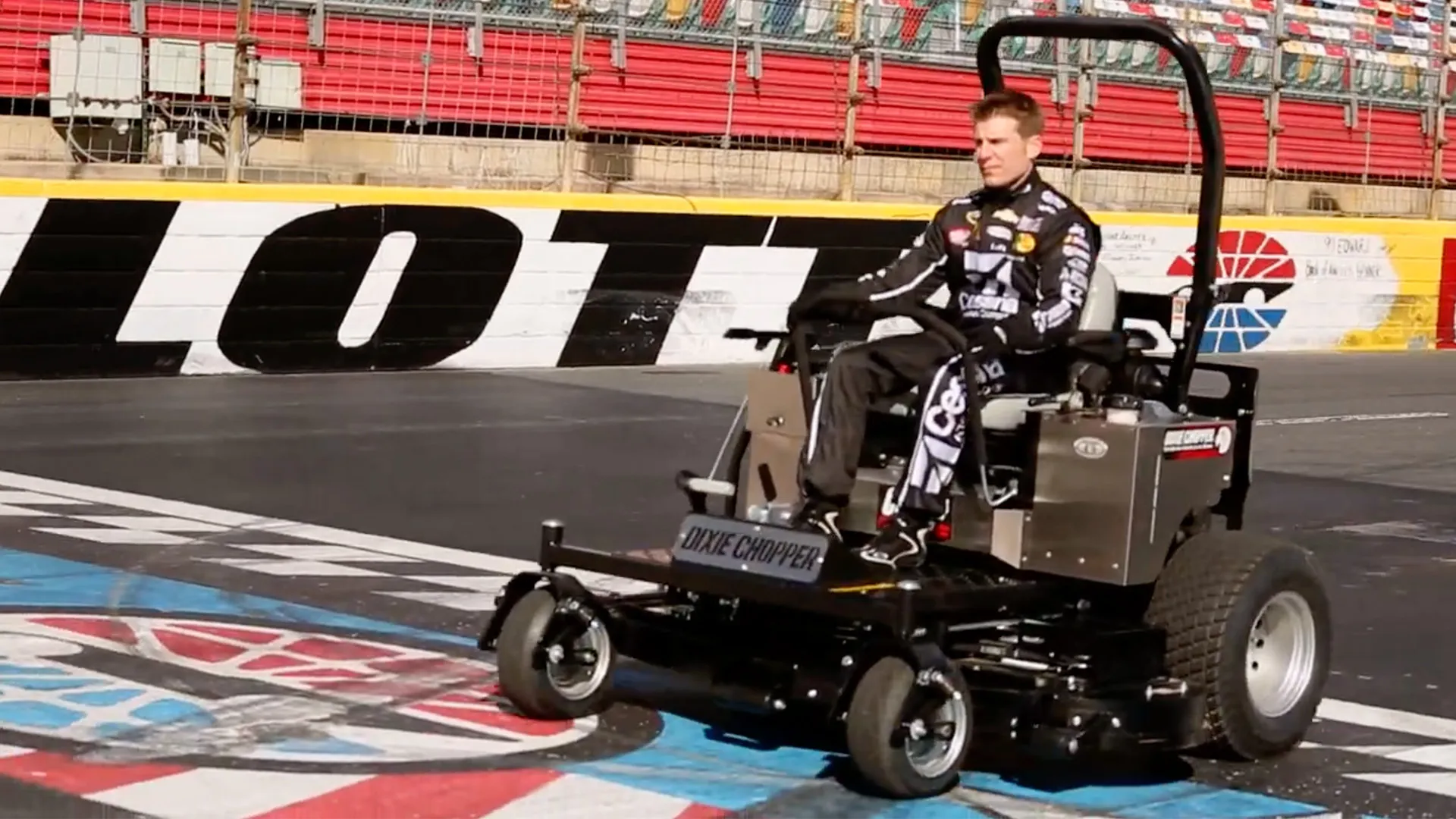 NASCAR Cup driver Jamie McMurray drives a Dixie Chopper mower on Charlotte Motor Speedway